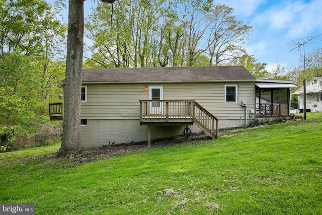 back of property featuring a yard and a wooden deck