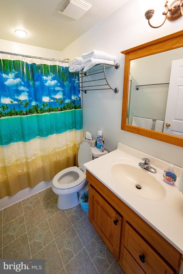 bathroom featuring toilet and vanity