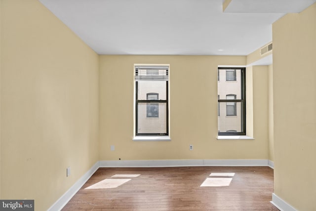 spare room with light hardwood / wood-style flooring