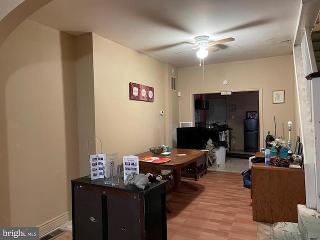 interior space featuring arched walkways, visible vents, and ceiling fan