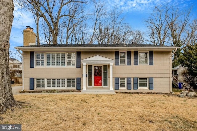 raised ranch with a front yard