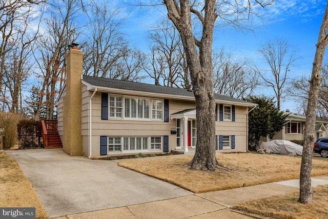 raised ranch with a front yard