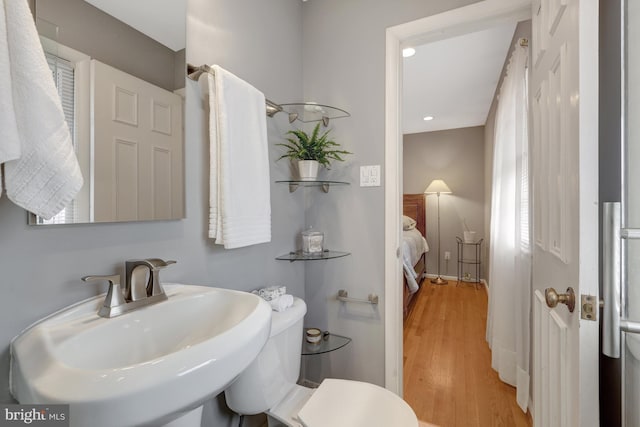 bathroom featuring sink, toilet, and hardwood / wood-style floors