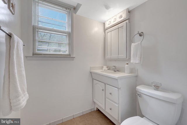 bathroom with vanity, toilet, and tile patterned floors