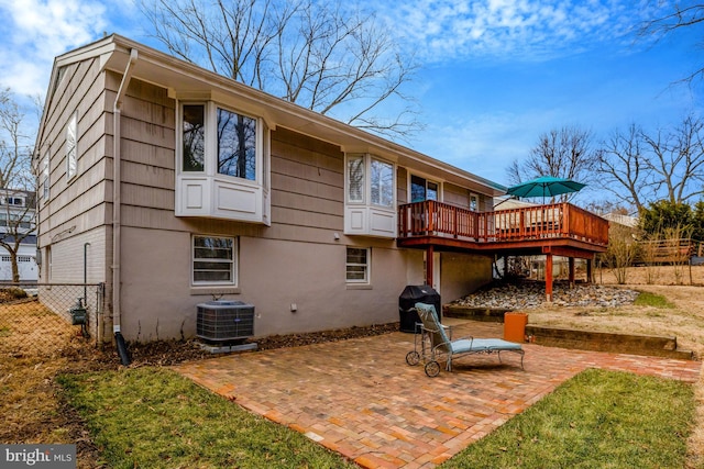 rear view of house with central AC unit, a patio, and a wooden deck