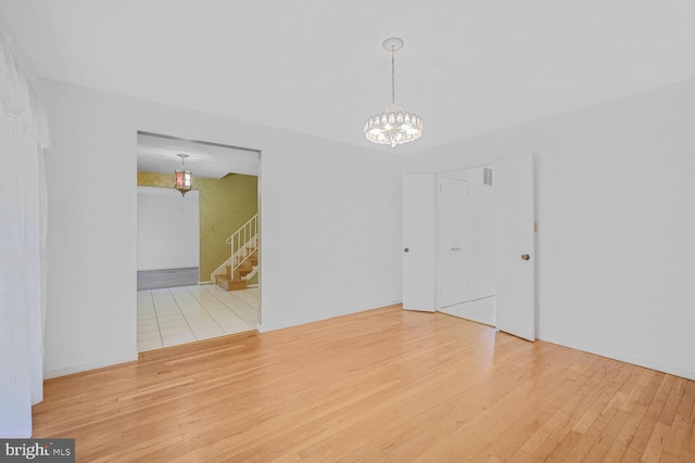 10628 Democracy Ln, Potomac, MD 20854 - empty room featuring wood finished floors, stairway, and a chandelier