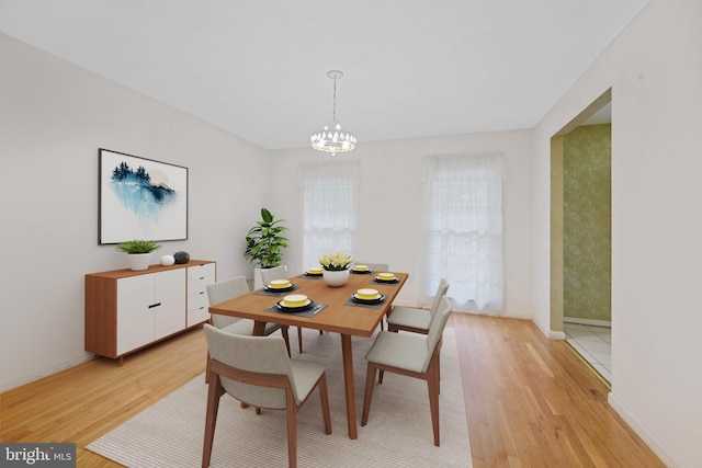 10628 Democracy Ln, Potomac, MD 20854 - dining space featuring light wood-style flooring, a chandelier, and baseboards