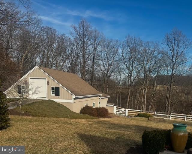 view of home's exterior featuring a yard and fence