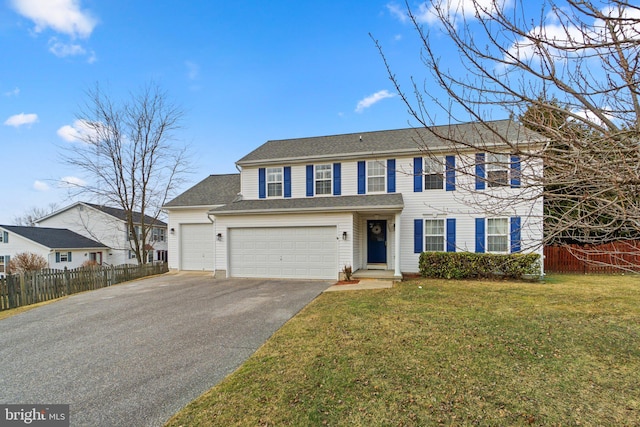 view of front facade with a garage, driveway, a front lawn, and fence