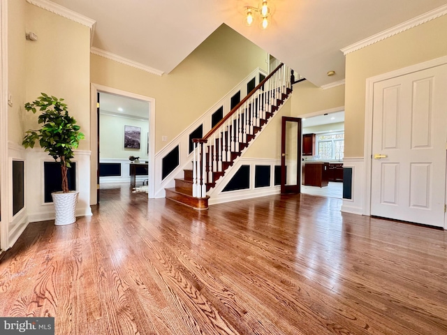 interior space featuring stairway, wood finished floors, and ornamental molding