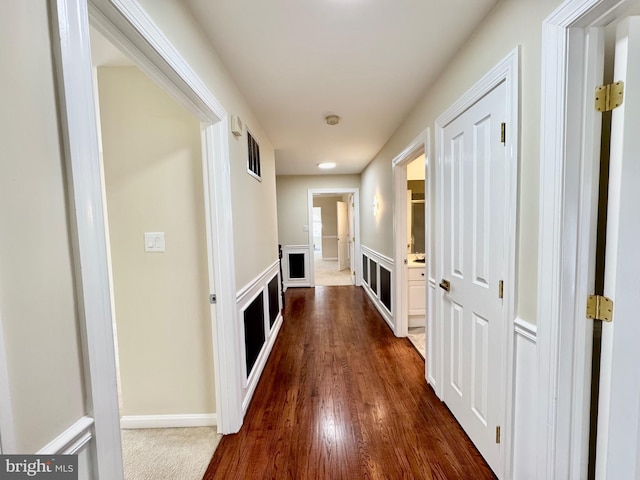 hall with dark wood-type flooring