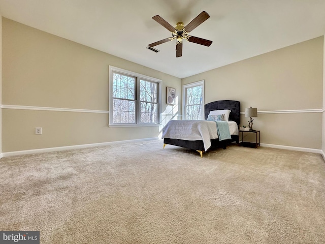 bedroom featuring baseboards, ceiling fan, and light colored carpet