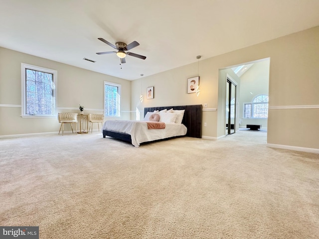 carpeted bedroom featuring multiple windows, visible vents, and baseboards