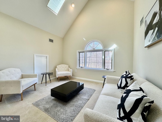 living area with carpet floors, high vaulted ceiling, baseboards, and visible vents