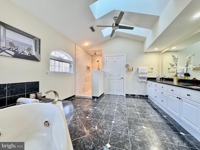 bathroom featuring double vanity, baseboards, visible vents, lofted ceiling with skylight, and walk in shower