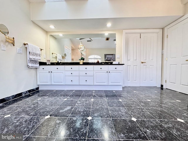 bathroom featuring recessed lighting, baseboards, and double vanity