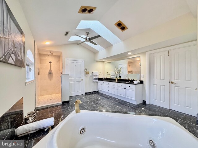 bathroom featuring a stall shower, visible vents, lofted ceiling with skylight, a whirlpool tub, and vanity