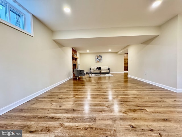 interior space featuring recessed lighting, baseboards, and wood finished floors