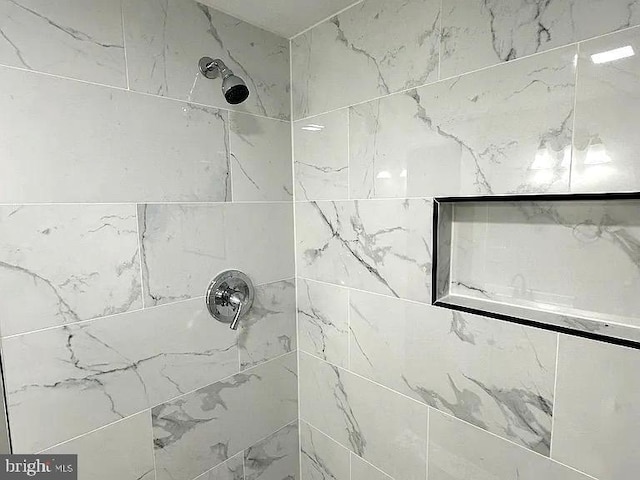 bathroom with tiled shower