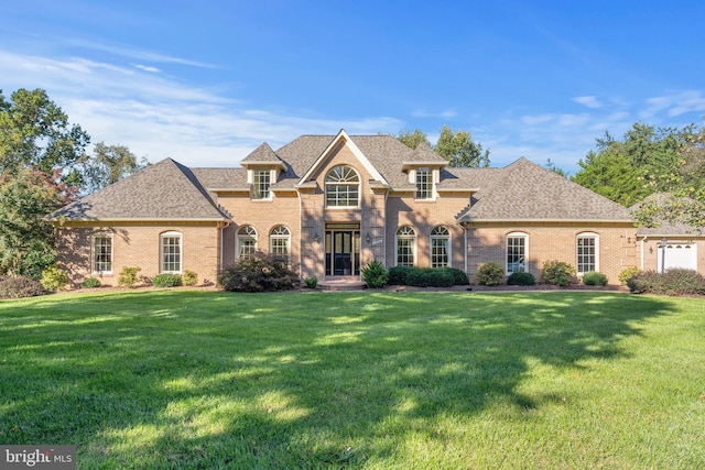 10928 Woodland Falls Dr, Great Falls, VA 22066 - view of front of property featuring a front lawn, brick siding, and a shingled roof