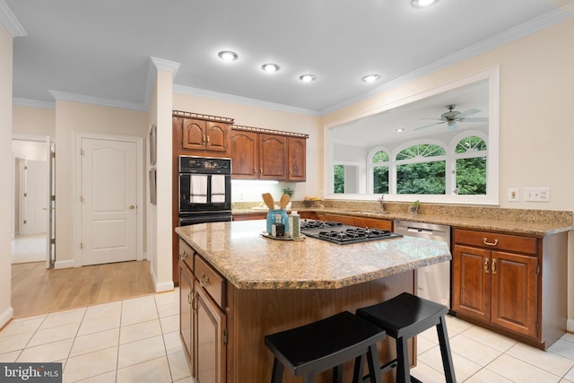 10928 Woodland Falls Dr, Great Falls, VA 22066 - kitchen with dishwasher, cooktop, a center island, a kitchen bar, and ceiling fan