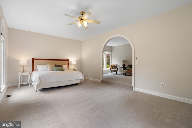 10928 Woodland Falls Dr, Great Falls, VA 22066 - bedroom featuring arched walkways, carpet flooring, baseboards, and a ceiling fan