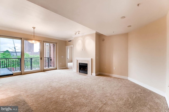 unfurnished living room featuring light carpet, crown molding, a fireplace with flush hearth, and baseboards