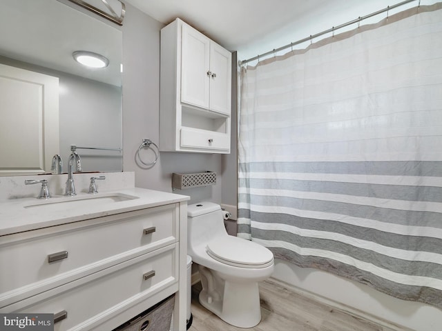 full bathroom featuring vanity, toilet, and wood finished floors