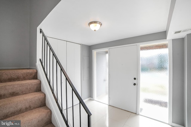 entryway with stairs and visible vents