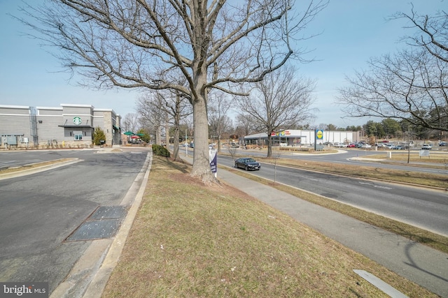 view of street with sidewalks and curbs