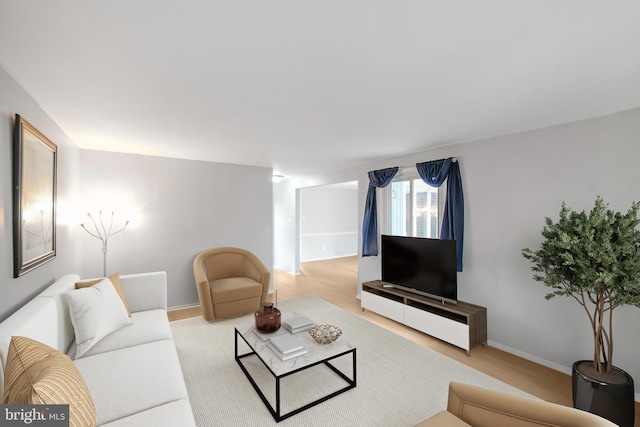 living area with wood finished floors and baseboards