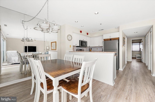 dining area with light wood-type flooring