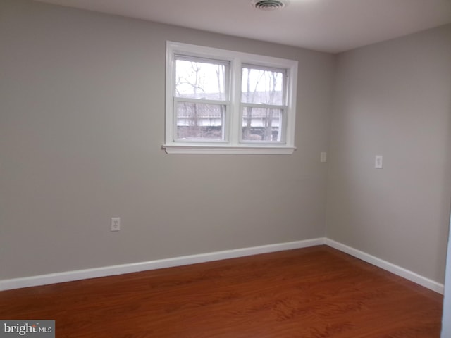 empty room featuring hardwood / wood-style flooring