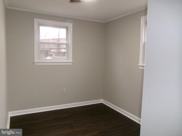 empty room with ornamental molding and dark hardwood / wood-style floors