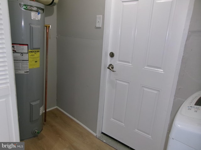 utility room featuring water heater and washer / clothes dryer