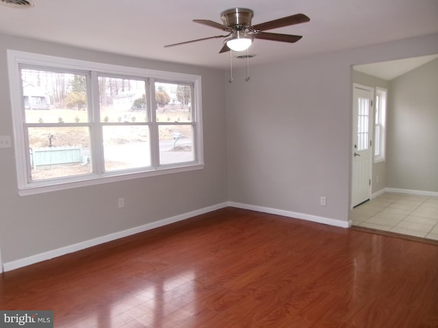 empty room featuring ceiling fan and wood-type flooring