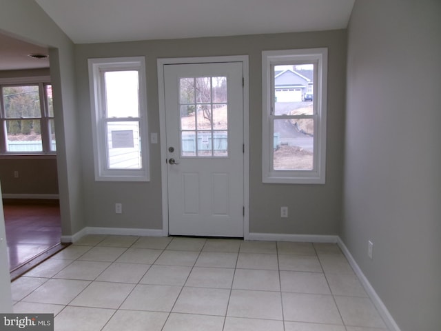 doorway to outside featuring a healthy amount of sunlight and light tile patterned floors