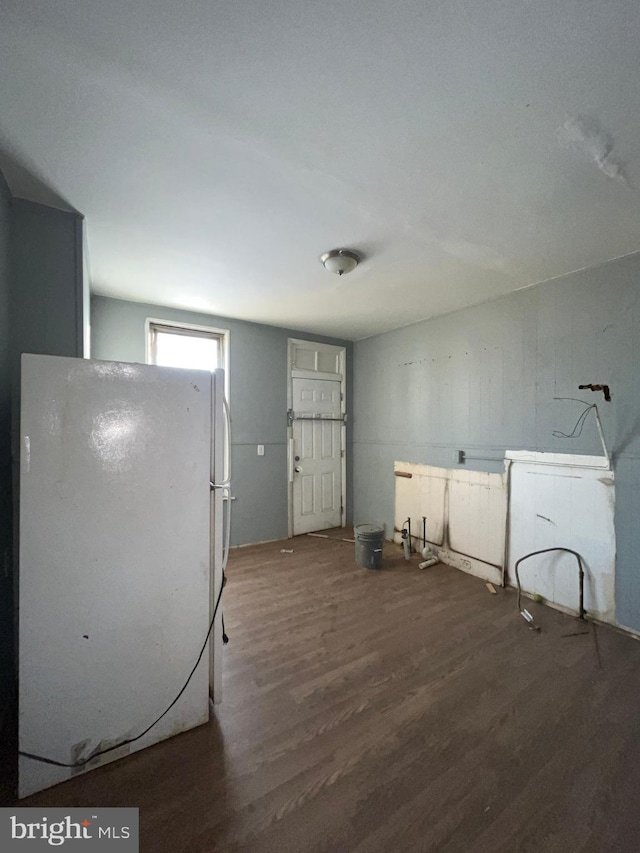 kitchen with white fridge and dark hardwood / wood-style floors