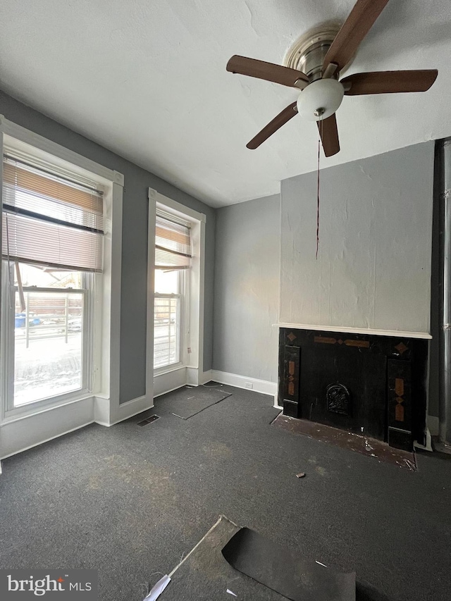 unfurnished living room with dark carpet