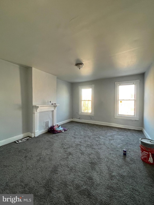 unfurnished living room featuring carpet flooring