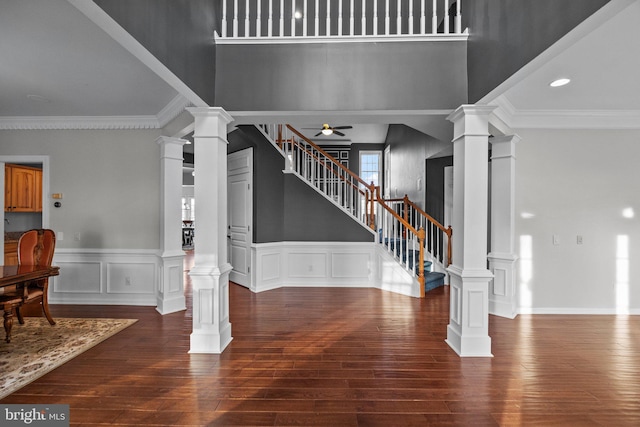 foyer with crown molding, stairway, decorative columns, and ceiling fan