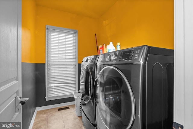 laundry room featuring visible vents, baseboards, washing machine and clothes dryer, laundry area, and tile patterned floors