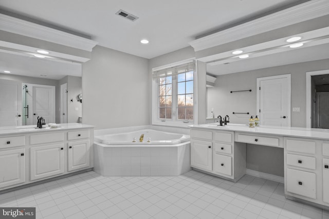 bathroom featuring two vanities, a bath, visible vents, and a sink