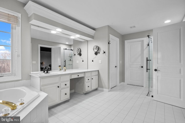 bathroom featuring vanity, a bath, a shower stall, and tile patterned flooring