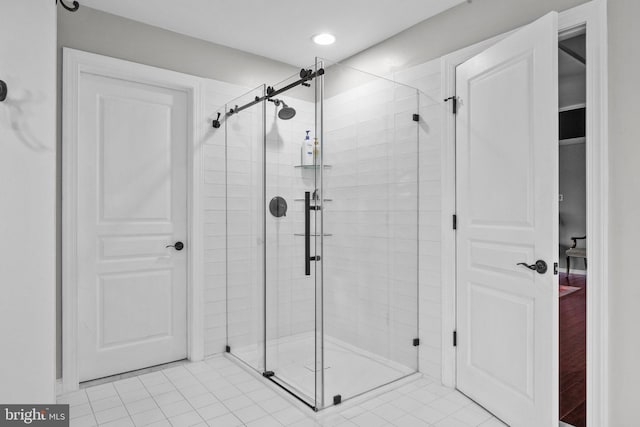 bathroom with recessed lighting, a stall shower, and tile patterned flooring