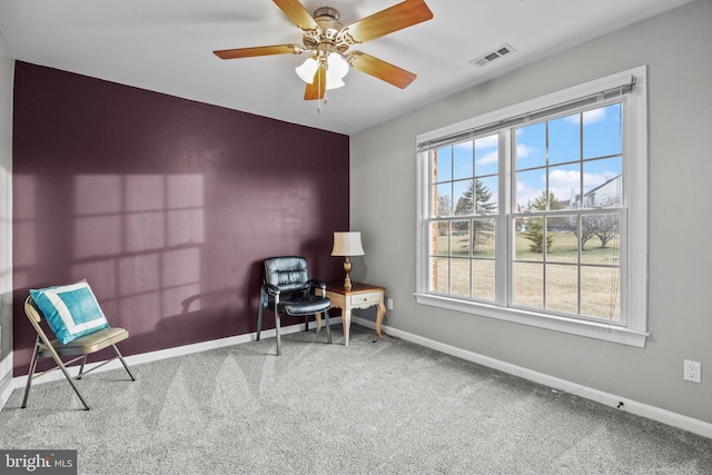 sitting room with carpet flooring, a healthy amount of sunlight, visible vents, and baseboards