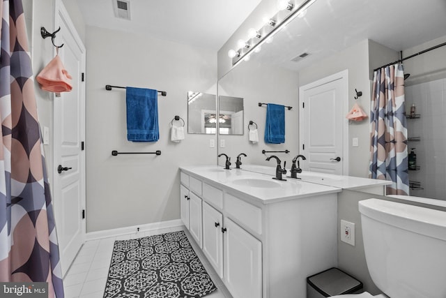 full bathroom featuring double vanity, visible vents, and a sink