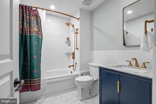 full bathroom with vanity, visible vents, tile walls, toilet, and shower / tub combo with curtain