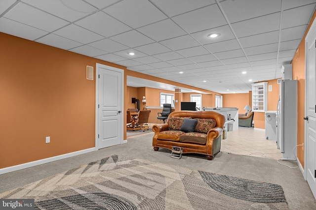 living room featuring a drop ceiling, baseboards, light carpet, and recessed lighting