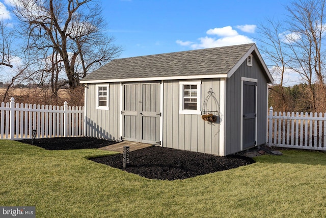 view of shed featuring fence private yard